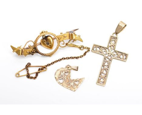 A 9CT GOLD CROSS PENDANT AND A YELLOW METAL BROOCH AND PENDANT, the cross pendant with an openwork scroll design, fitted with