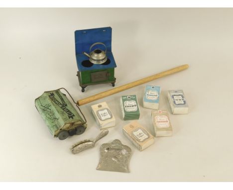 MINIATURE PACKAGING.Six miniature packets of various sugars, a miniature stove, a miniature crumb tray & brush & a 'Little Wo