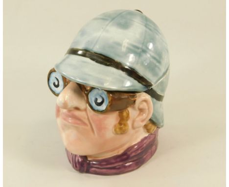 TOBACCO JAR.A tobacco jar, in the form of a motorist's head, based on prints of cartoon chauffeur's heads.
