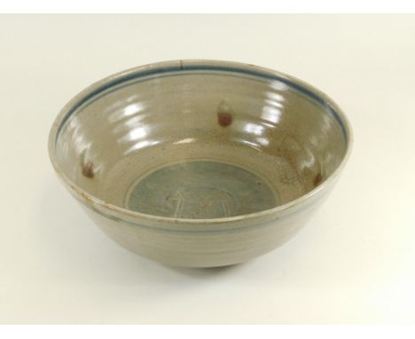 BERNARD LEACH.A large deep Leach Pottery bowl, decorated in the centre with a well-head by Bernard Leach. Firing faults. Diam