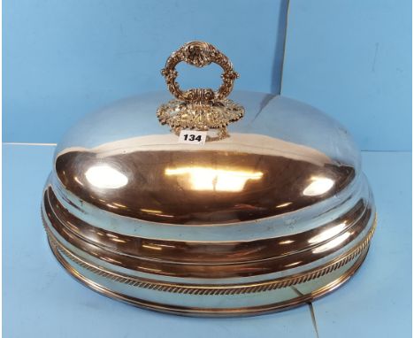 A GRADUATED SET OF THREE VICTORIAN OVAL SILVER PLATED MEAT DISH COVERS with ornate foliate ring handles.  (3)   