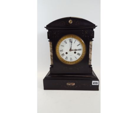 A LATE 19TH CENTURY BLACK SLATE MANTLE CLOCK with incised decoration and variegated marble pillasters, circular enamel dial w