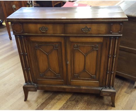 A REPRODUCTION MAHOGANY SHERATON REVIVAL SIDE CABINET, two frieze drawers above a pair of blind astragal doors flanked by spl