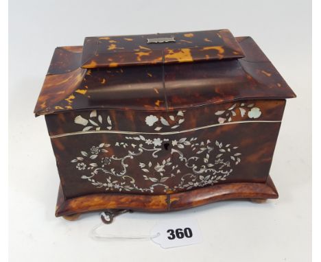 A 19TH CENTURY SERPENTINE FRONTED TORTOISESHELL VENEERED TEA CADDY, the front inlaid with foliate mother-of-pearl and pewter 