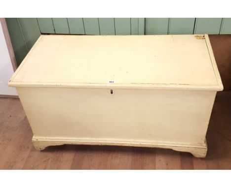 A 19TH CENTURY PAINTED PINE BLANKET BOX, hinged lid revealing a candle box, raised on bracket feet, 38 ins x 18 1/2 ins.   