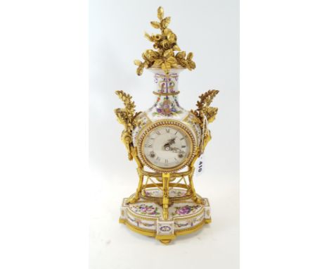 A REPRODUCTION PORCELAIN CASED MANTLE CLOCK, the circular dial with twin train movement, floral decorated case with gilt meta
