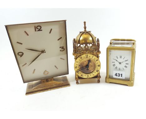 AN EARLY 20TH CENTURY BRASS 8 DAY CARRIAGE CLOCK, faults, 4 1/2 ins high a miniature Smith's brass LANTERN CLOCK, 7 ins high 