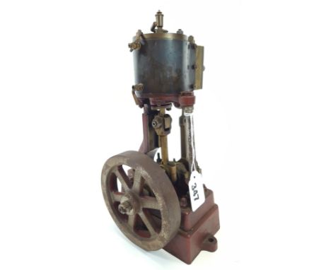 AN EARLY 20TH CENTURY CAST-IRON SINGLE BORE PLATFORM ENGINE with six spoke 4 1/2 ins flywheel, 11 ins high. SEE ILLUSTRATION.