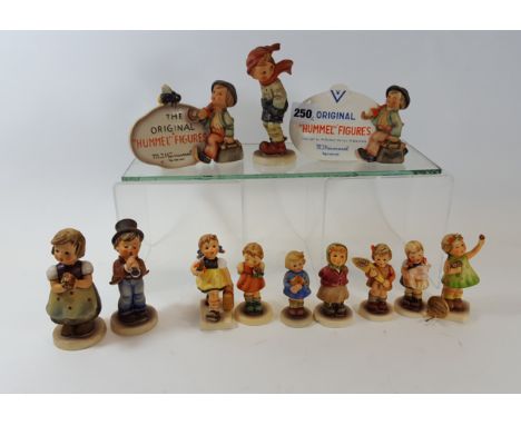 A GOEBEL HUMMEL "THE ORIGINAL" PLAQUE, 4 ins high, a glazed DITTO, 3 3/4 ins high and ten ditto standing FIGURES, 5 1/2 ins t
