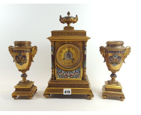 A 19TH CENTURY FRENCH GILT BRASS AND CHAMPLEVE ENAMEL CLOCK GARNITURE twin train Marti movement, the enamelled urn top case w