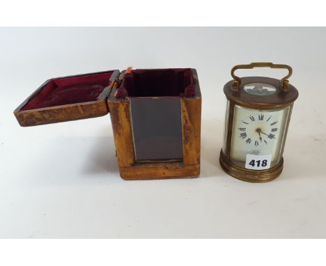 AN EARLY 20TH CENTURY FRENCH CIRCULAR 8 DAY BRASS CARRIAGE CLOCK, white enamel dial, 4 1/2 ins high together with original ca