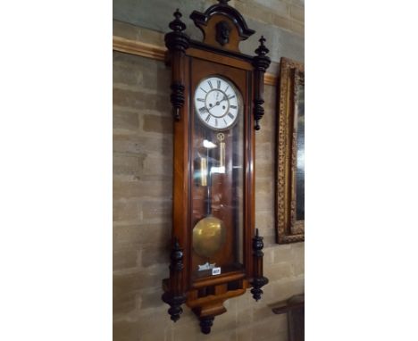 A VICTORIAN WALNUT AND EBONISED VIENNA REGULATOR WALL CLOCK, circular enamel dial with twin weight movement enclosed by a gla