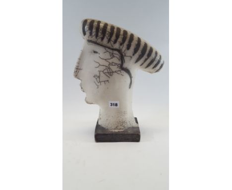 KATE REYNOLDS, A GLAZED CERAMIC HEAD on an integral rectangular base, 14 ins high.   