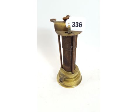 A 19TH CENTURY BRASS AND IRON DAVY TYPE MINERS SAFETY LAMP with wire gauze and hinged hood, possibly by H. Watson, Newcastle,