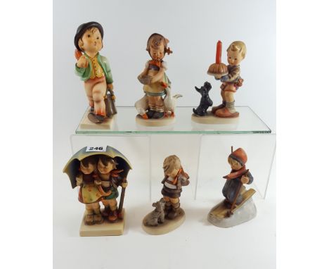 A LARGE GOEBEL HUMMEL FIGURE, children under and umbrella, 6 1/2 ins high, another entitled "Merry Wanderer" 7 ins high, anot