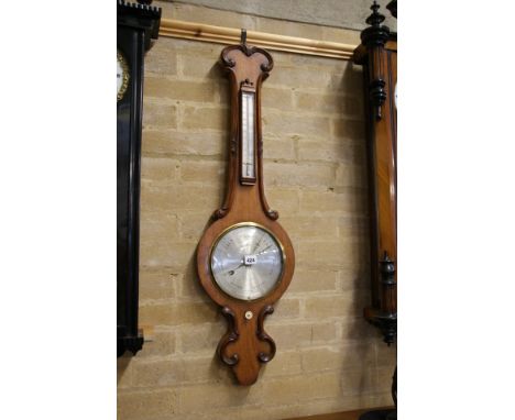 BERRY, HUNTINGDON, A 19TH CENTURY WALNUT BANJO BAROMETER, 8 ins silvered dial with thermometer above, the case with carved "C