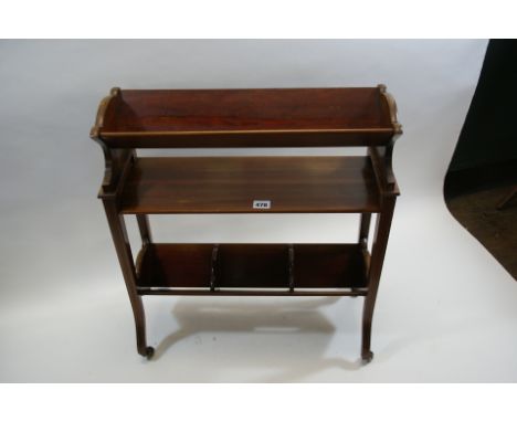 AN EDWARDIAN INLAID MAHOGANY BOOK TROUGH, with V-shaped troughs and shelf raised on end supports with downswept legs and cast