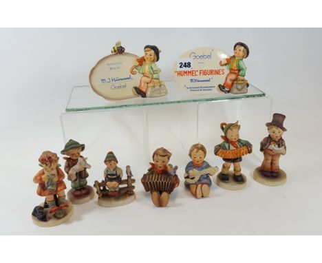 A GOEBEL HUMMEL FIGURINES PLAQUE, 4 ins high, a ditto "Authorised Dealer" PLAQUE, a ditto FIGURE of a boy with sheet music, 5