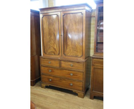 A REGENCY PERIOD MAHOGANY LINEN PRESS, the moulded cornice above a pair of ebony beaded panelled doors enclosing sliding tray