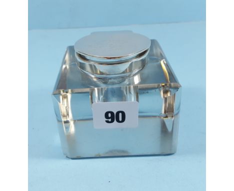 A LATE VICTORIAN SQUARE GLASS INKWELL, the hinged silver lid with presentation inscription, maker:- S &amp; A, Birmingham 190
