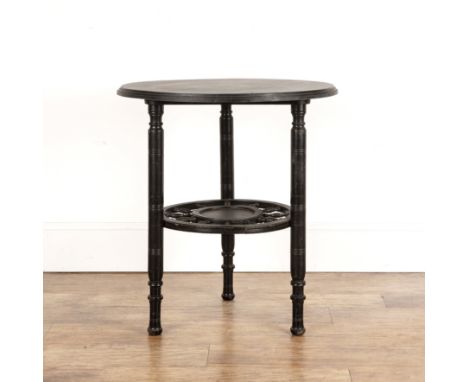 In the manner of Edward William Godwin (1833-1886) Aesthetic movement ebonised table, with circular top and spoked under tier