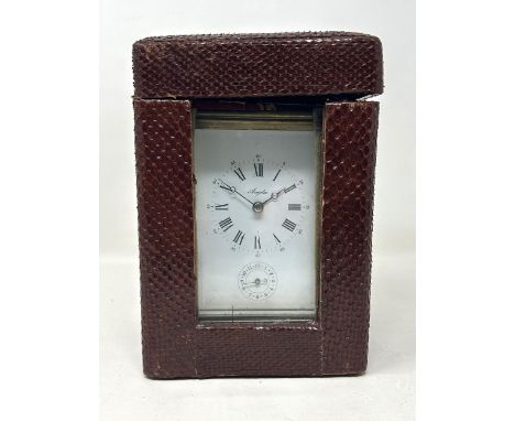 A carriage clock, by Angelus, with a repeat and an alarm, in a faux snake skin travel case, 20 cm high 