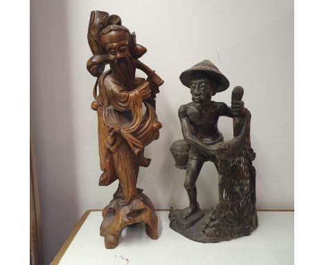 A Chinese carving of a figure, converted to a lamp base, 55 cm high, and an Eastern carving of a figure, 43 cm high, a Chines