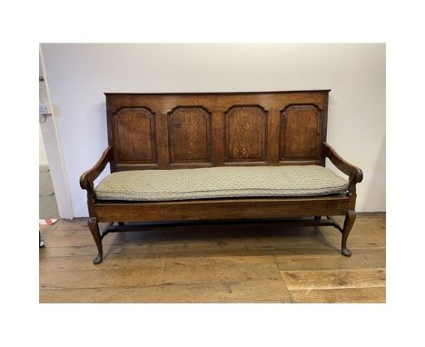 A George III oak settle, with a four panel back and cabriole front legsA good colourDepth - 59 cmHeight - 113 cmWidth - 181 c