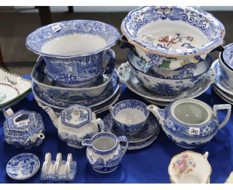 A collection of transfer printed blue and white pottery including platters, punch bowls, dishes , a Burns pattern teapot, Spo