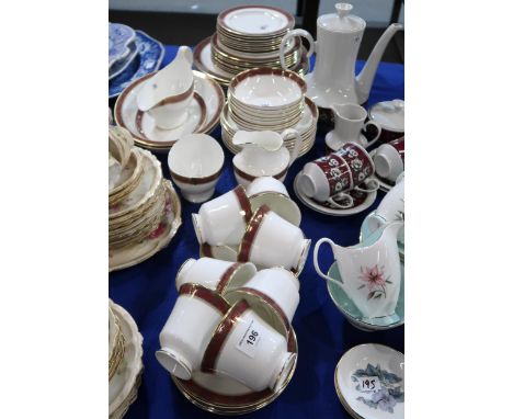 A Royal Doulton Martinique pattern dinner service comprising plates, bowls, oval dishes, sauce tureen, cups and saucers, milk