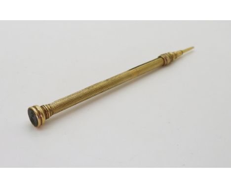 A yellow metal propelling pencil by J. Butler &amp; Co London, the end set with a bloodstone intaglio engraved with a Crown s
