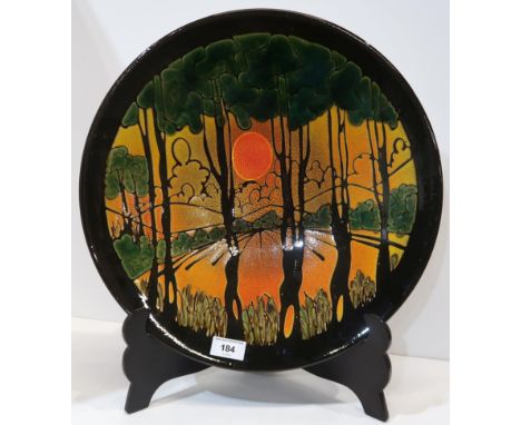 A large Poole Aegean charger decorated with trees and a sunset Condition Report:Available upon request
