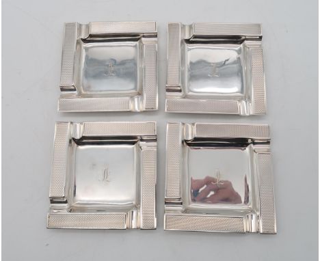 A set of four Art Deco silver ash trays, by Barker Brothers, Birmingham, of square form with engine turned decoration, 323gms