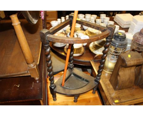 An oak barley twist stick stand with a walking stick