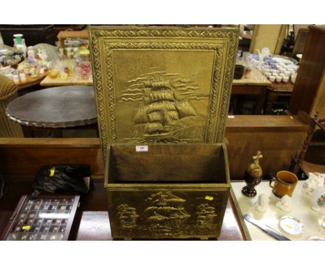 A brass embossed firescreen and magazine rack