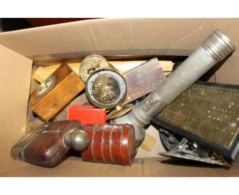 A box of various sundries to include a brass cribbage board; a leather and glass hip flask; a small clock; wooden rules etc. 