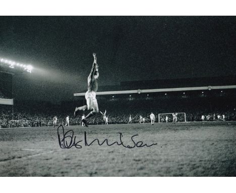 Football Autographed BOB WILSON 12 x 8 Photo : B/W, depicting Arsenal goalkeeper BOB WILSON jumping with joy after team mate 