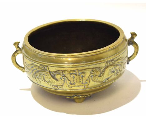 19th century Chinese circular brass bowl with raised decoration of birds holding a scroll, two side handles (soldered repairs