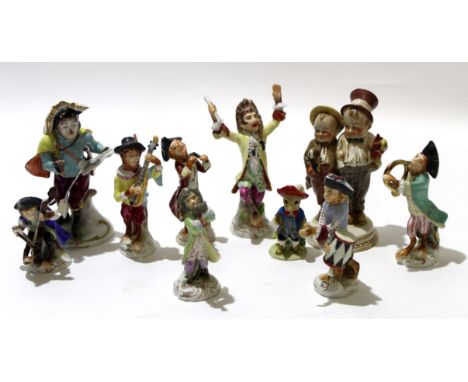 Group of Continental porcelain monkey band figures including a conductor, various musicians and a singer, together with a Goe