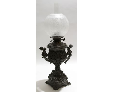 Metal pierced oil lamp with cherub handles, decorated in Renaissance style with circular globe, 88cm high 