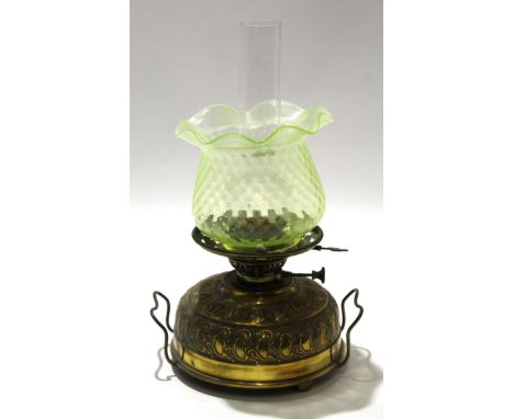 Brass table lamp with green shade, the brass reservoir with a chased rococo type design, 48cm high 