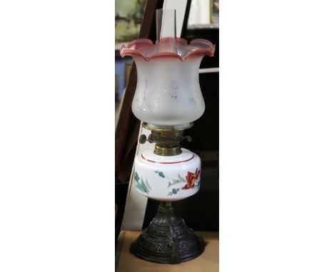 Late 19th century glass oil lamp, the white reservoir with floral design, the shade with floral design and shaped rim picked 