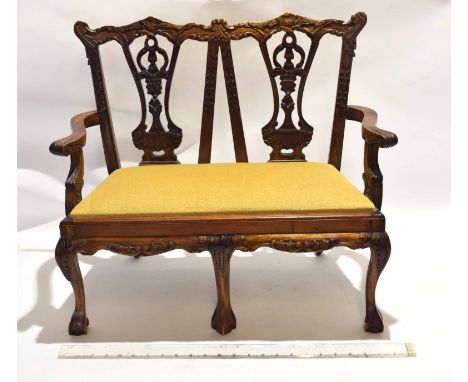 Reproduction carved hardwood miniature two-seater settee in Chippendale style with double chair back, supported on three fron