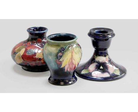 Two Moorcroft Pottery Vases, in the Leaf and Berries pattern and a candlestick in the Pansy pattern (3)Candlestick - 8.5cm , 