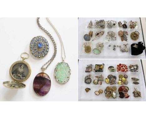 A Large Quantity of Jewellery, including silver and white metal pendants on chains, various brooches, bracelets etcThe jade p