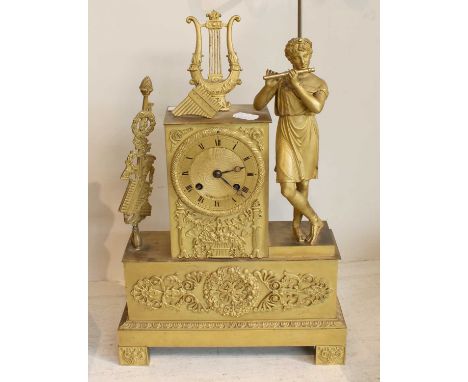 An Early 19th Century French Gilt Metal Striking Mantel Clock, case with a figure playing a flute and a lyre finial, rectangu