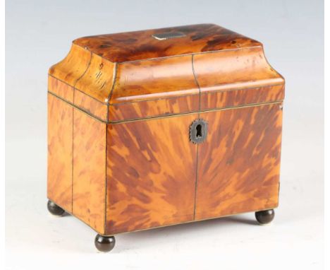 A Regency tortoiseshell tea caddy with overall metal stringing, the pagoda moulded lid revealing two lidded compartments, on 