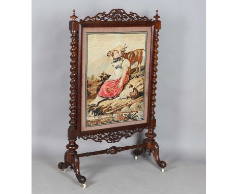 A large mid-Victorian walnut framed firescreen, inset with a woolwork panel and raised on carved cabriole legs, height 140cm,
