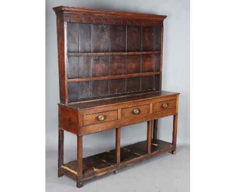 A George III provincial mahogany dresser, the plate rack above three drawers and chamfered supports united by a pine boarded 