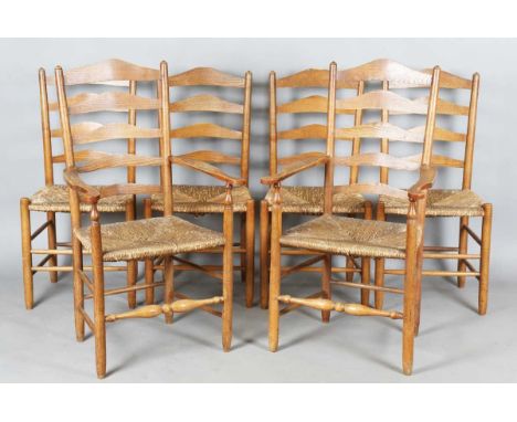 A set of six early 20th century Arts and Crafts ash framed ladder back chairs, in the manner of Ernest Gimson, each chair wit